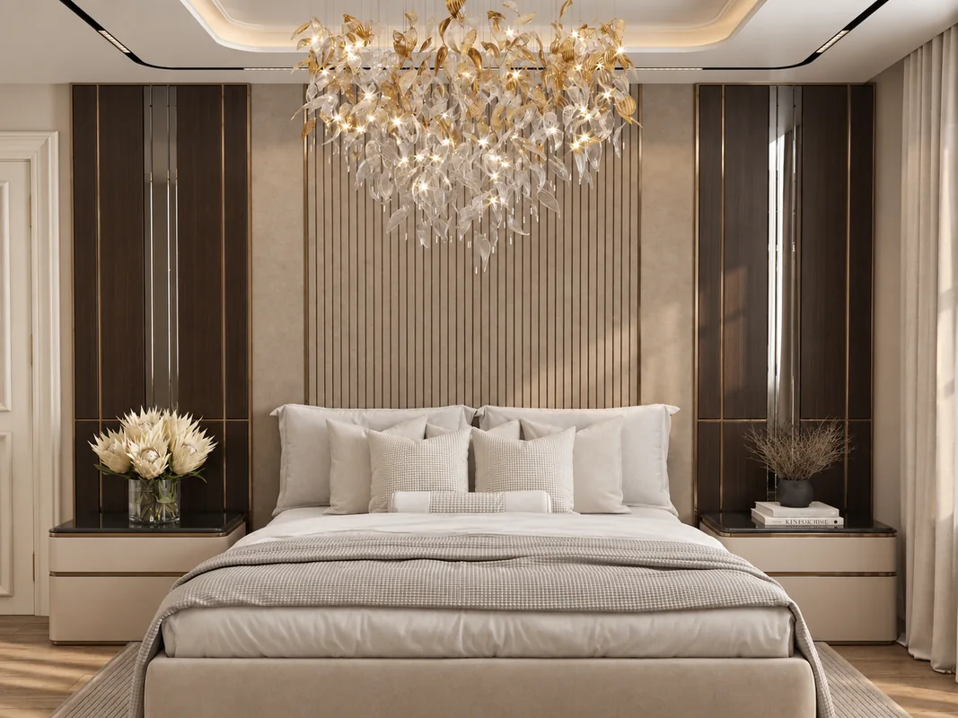 AD Flat bedroom with a fluted headboard wall, mirrored side panels and a decorative chandelier