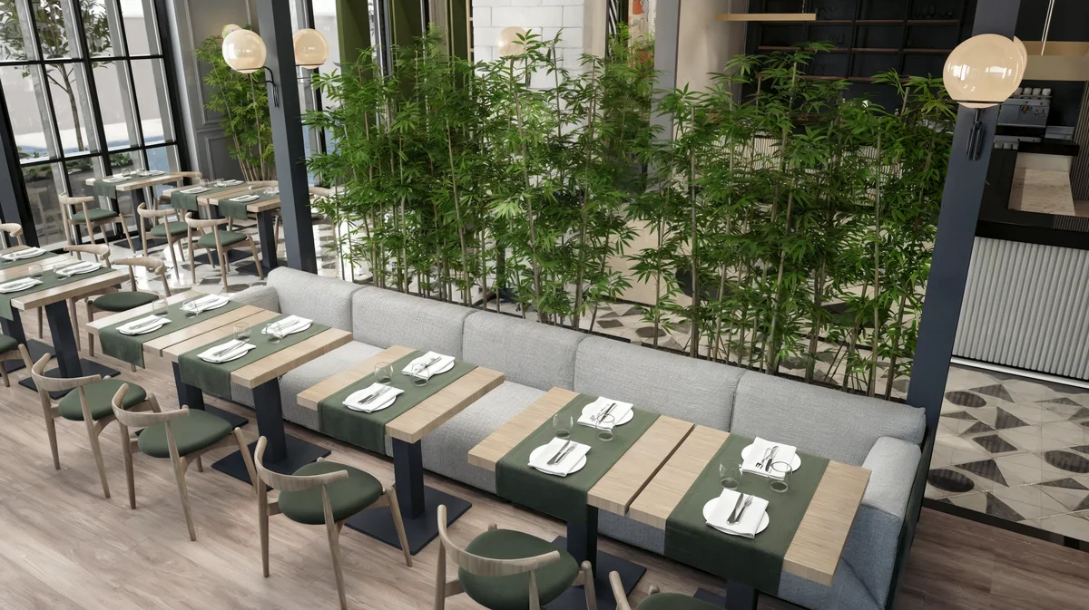 Wood tables and upholstered seating beside a bamboo screen at Oasis Cadde Café