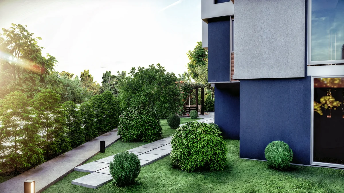 Doğa garden path beside the residential facade with evergreen planting and low lighting