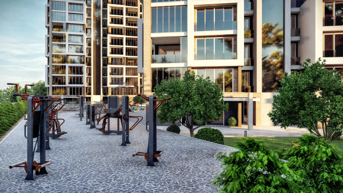 Doğa outdoor exercise equipment beside a paved path and residential facade