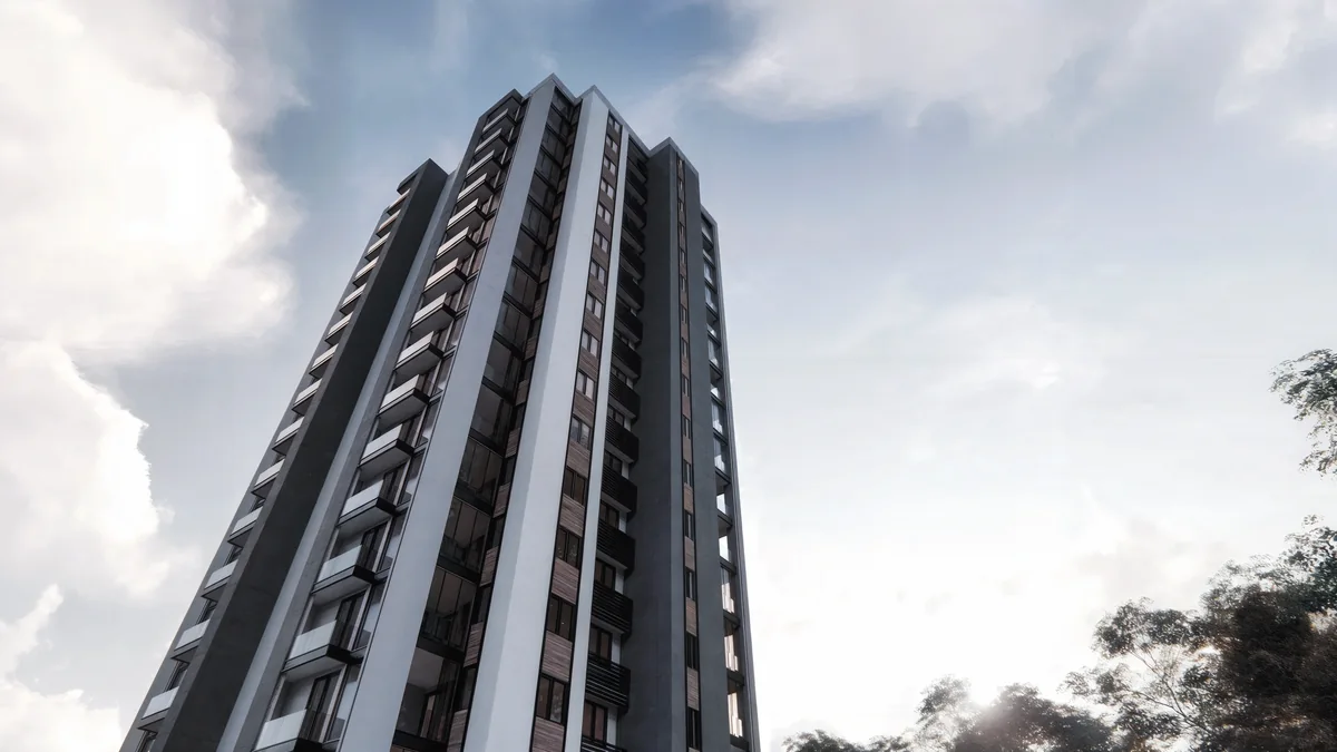 Low-angle Doğa tower view with a dark central spine, white edges and projecting balconies