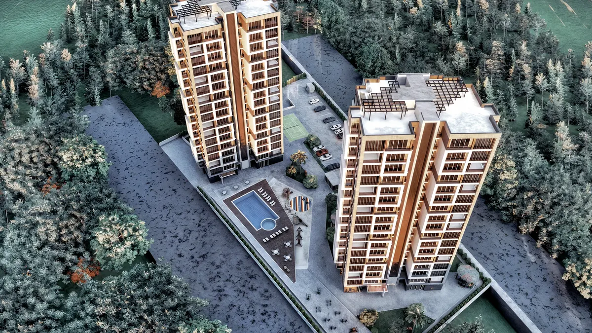 Reverse aerial view of Doğa residential towers and the landscaped site in Mersin