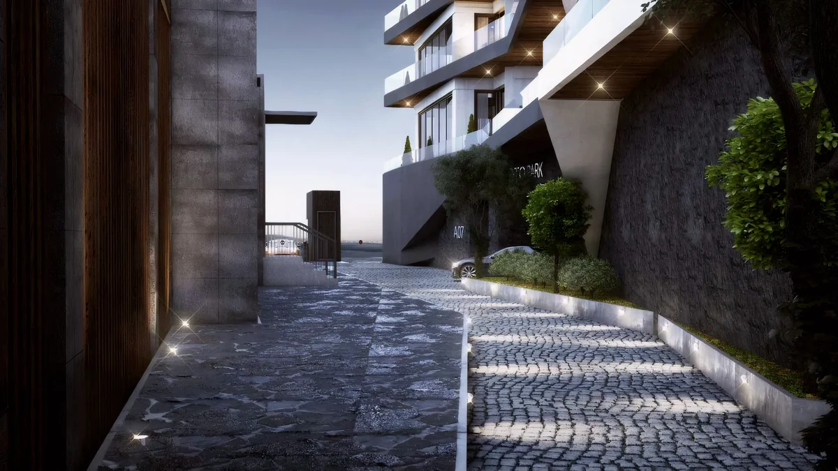 Cennet Yalova paved access route between residential blocks and a planted stone wall