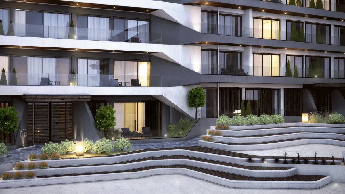 Cennet Yalova sculpted courtyard seating in front of illuminated apartments and glass balconies