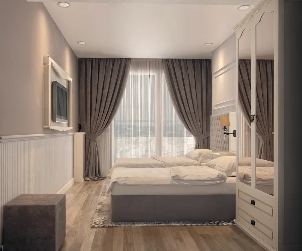 Side view of the Merter twin bedroom with a mirrored wardrobe and a wall-mounted television