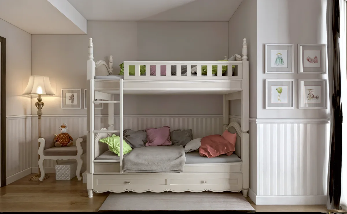 Merter children’s room with a white bunk bed, pastel cushions and framed drawings