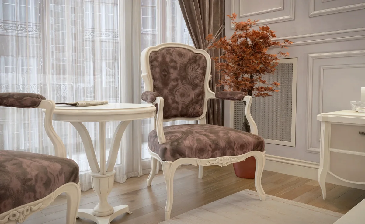 Merter living room detail with a floral upholstered armchair and a round white table