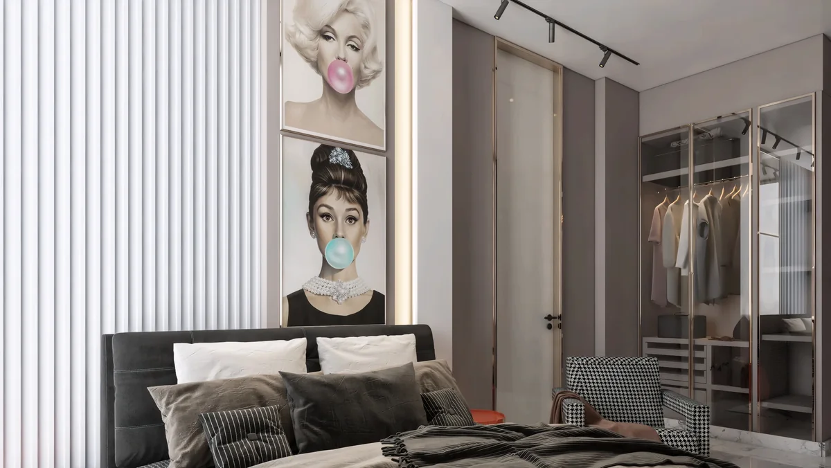 Dark bed and houndstooth chair with pop-art prints and a glazed wardrobe