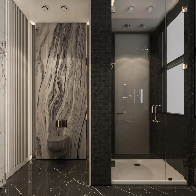 Glazed shower beside a veined stone wall and dark marble bathroom floor