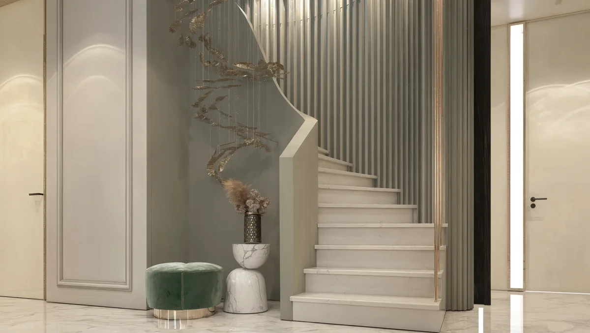 White marble staircase beside a ribbed wall and suspended leaf sculpture