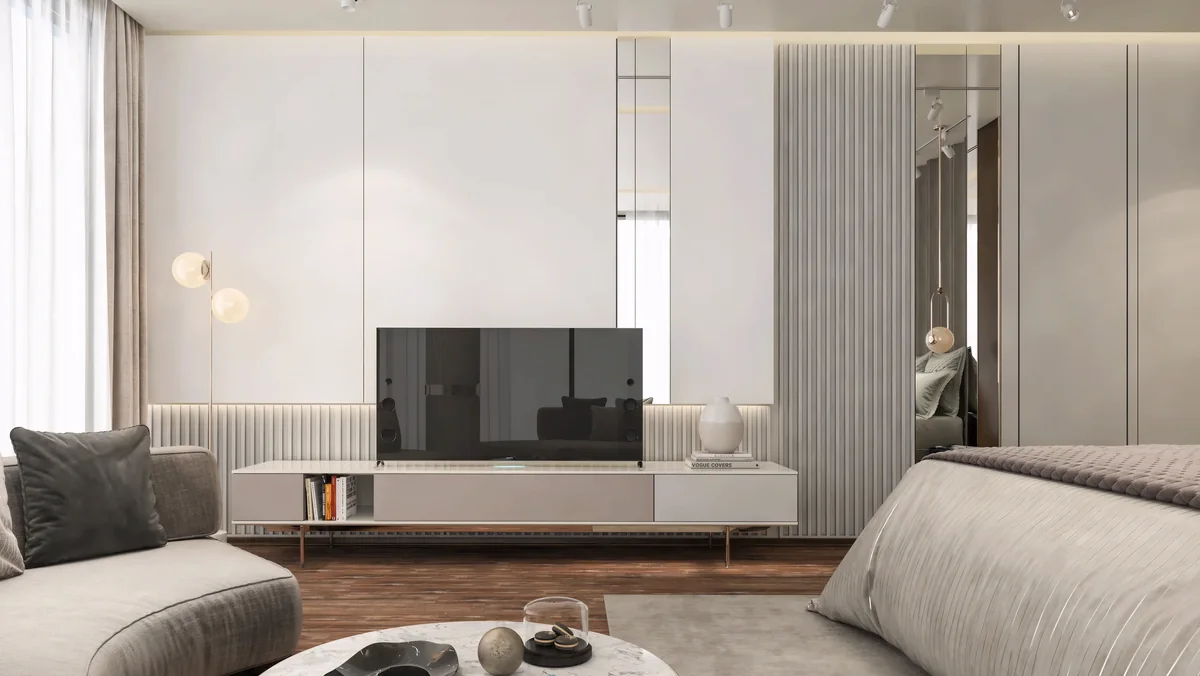 Bedroom sitting area with a white television console and mirrored wardrobe panels