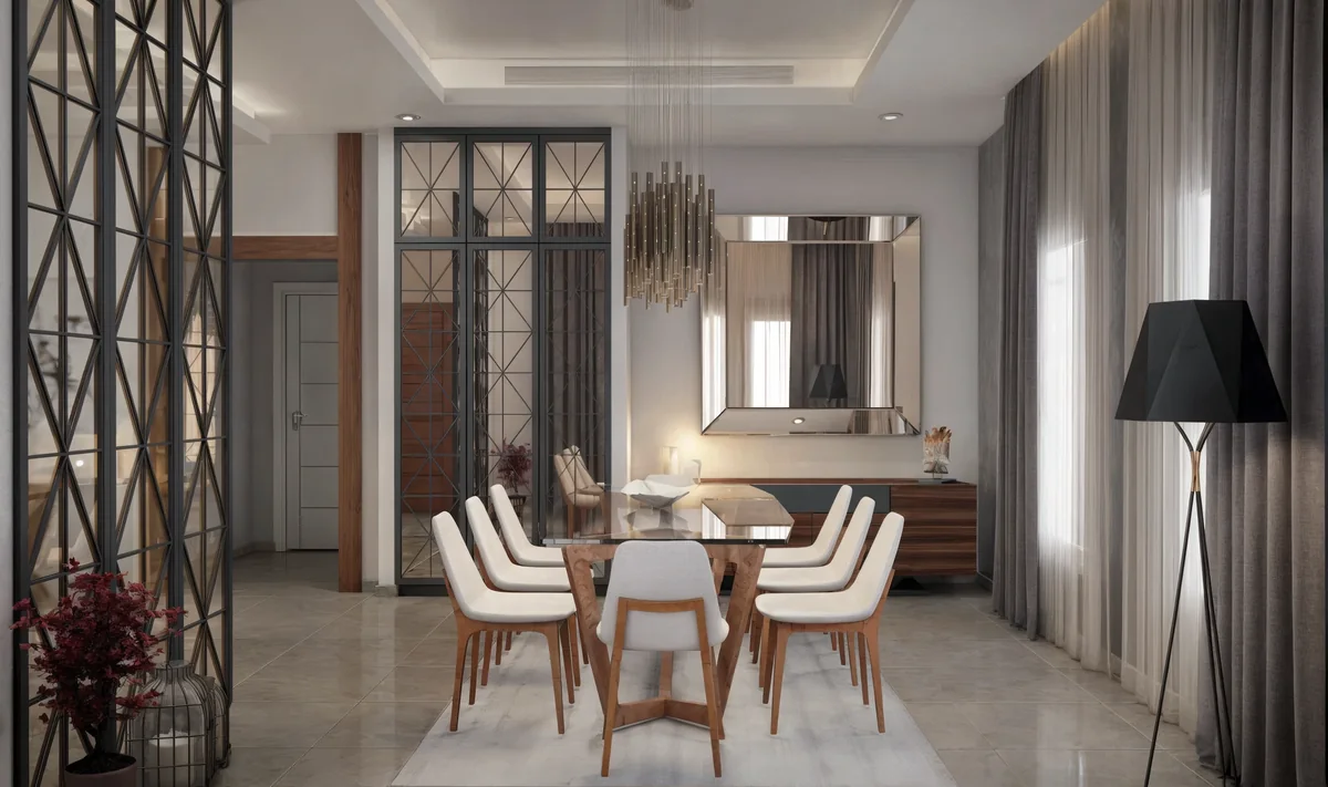 Dahlan Villa dining room with a glass table, pale chairs, brass chandelier and timber buffet