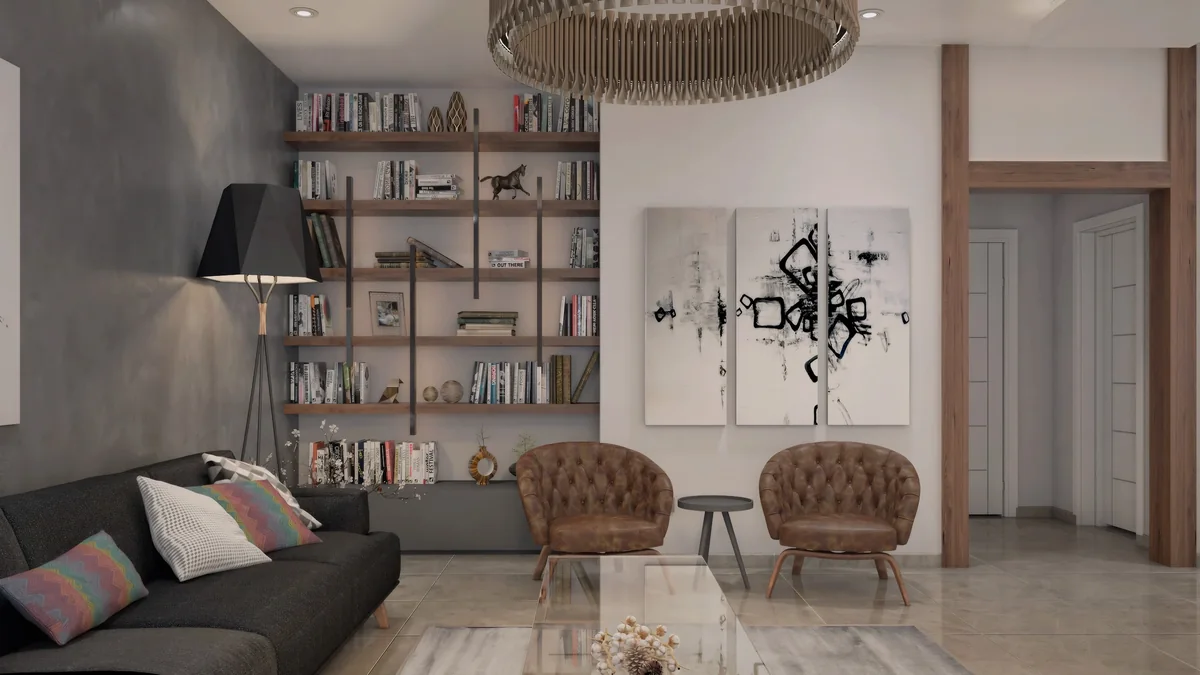Brown lounge chairs and open shelving face a charcoal sofa in the Dahlan Villa reception room
