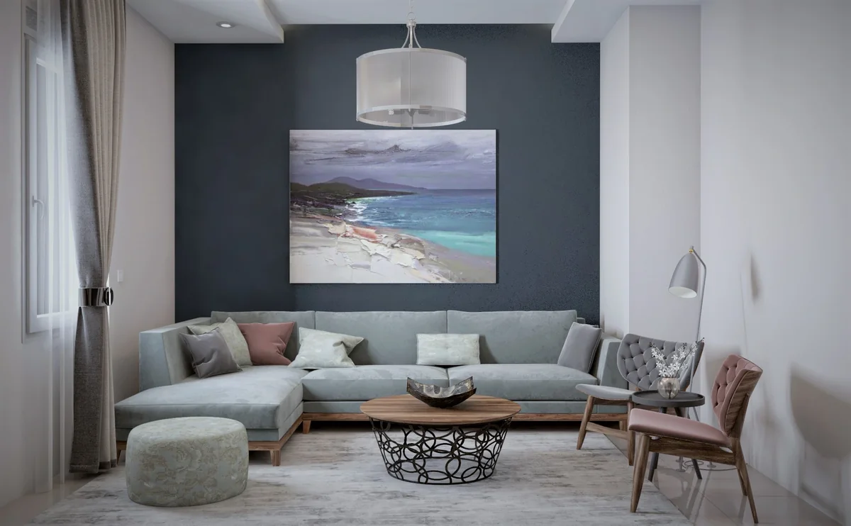 Pale sectional sofa and pastel chairs against a blue-grey feature wall at Dahlan Villa