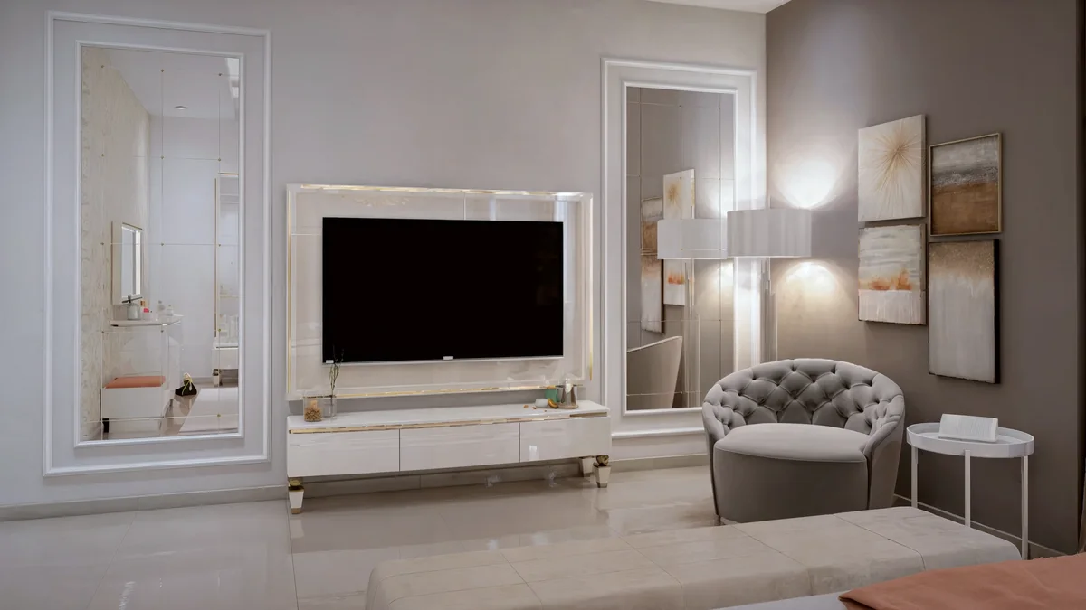 Dahlan Villa bedroom media wall with tall mirrors, a white cabinet and a tufted armchair