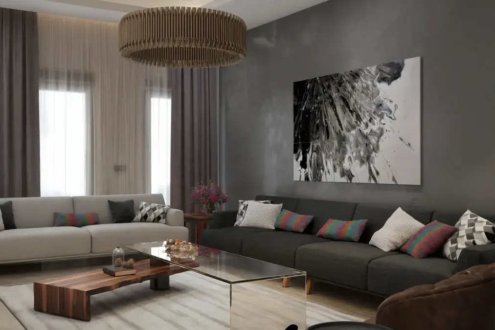 Dahlan Villa reception room with contrasting sofas, layered glass and timber tables and a circular pendant